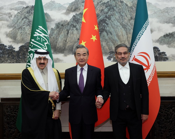 Chinese Foreign Minister Wang Yi joins the hands of Saudi National Security Advisor Musaad al-Aiban and Iranian Supreme National Security Council Secretary Ali Shamkhani after the trilateral talks in Beijing, 10 March 2023.